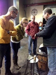 Blacksmithing instructor with students