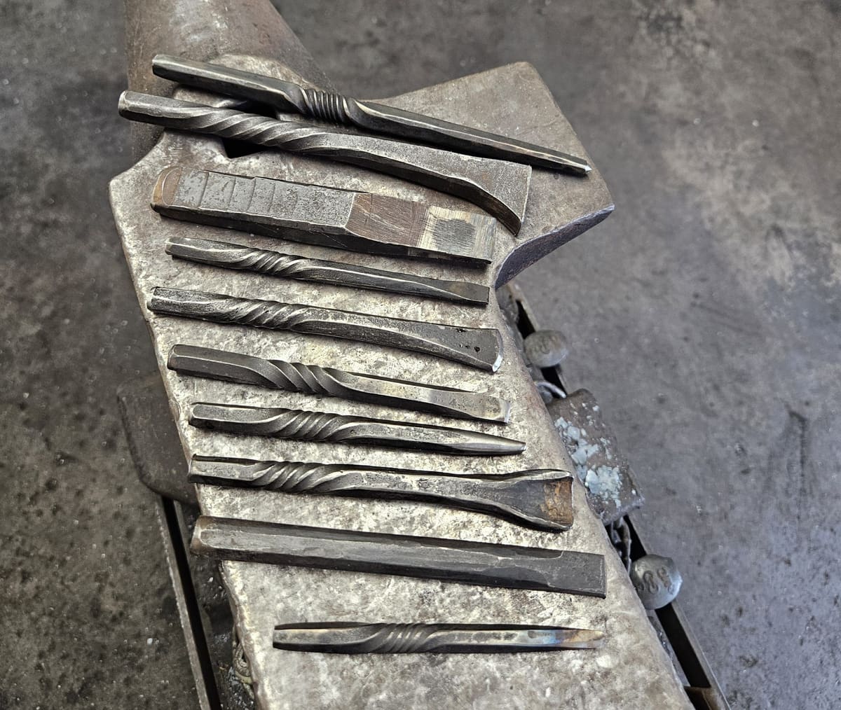 A rack of forged chisels and punches